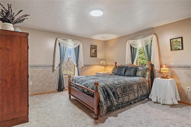 bedroom featuring carpet floors and a textured ceiling