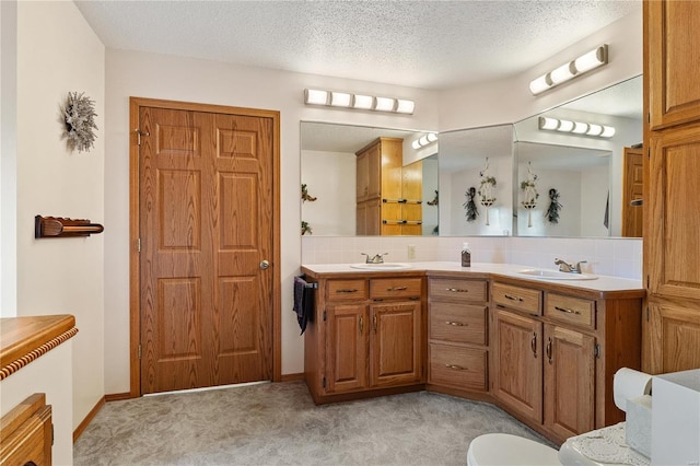 bathroom with vanity, a textured ceiling, and backsplash