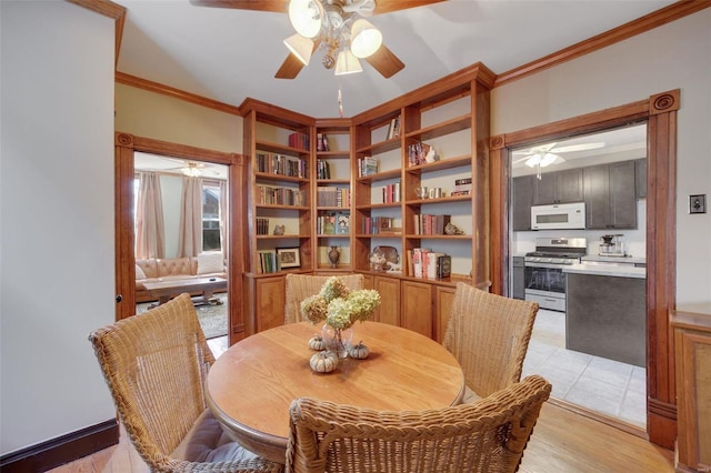 dining area featuring crown molding and light hardwood / wood-style flooring