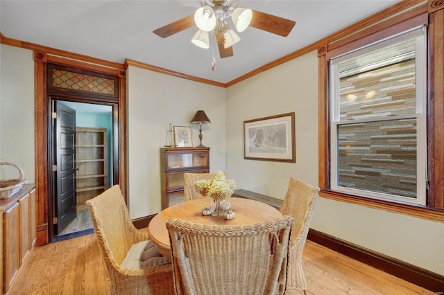 dining room with crown molding and light wood-type flooring