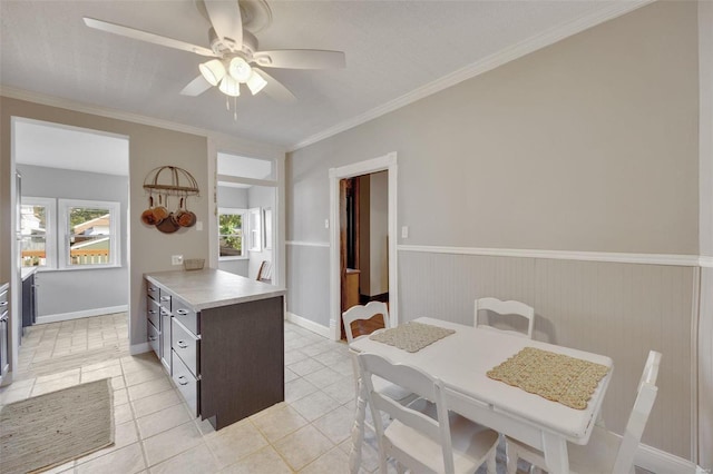 kitchen with crown molding, dark brown cabinets, ceiling fan, and light tile patterned flooring