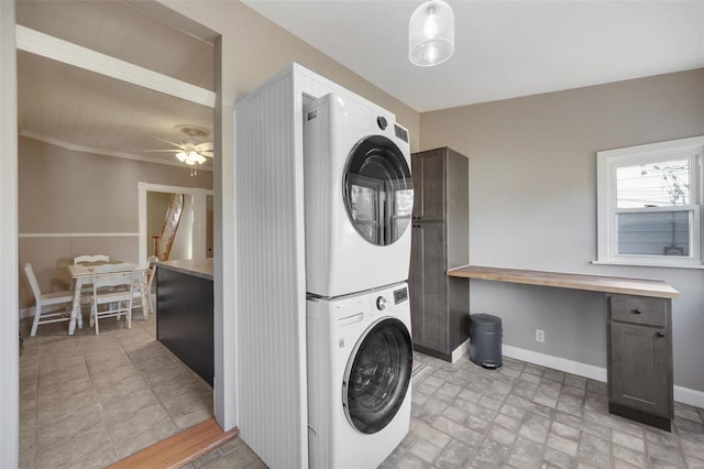 clothes washing area with ceiling fan and stacked washing maching and dryer