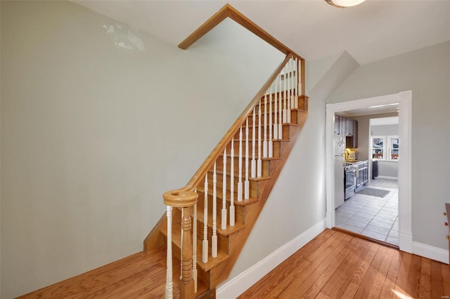 staircase with hardwood / wood-style flooring