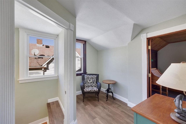 sitting room featuring vaulted ceiling and light hardwood / wood-style floors