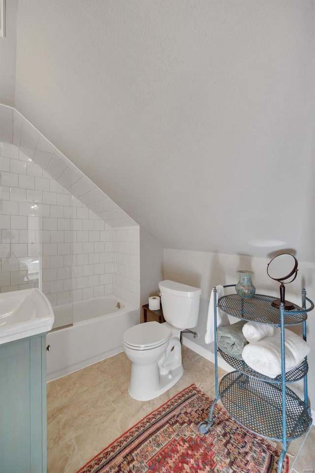 full bathroom with vanity, tiled shower / bath, and toilet