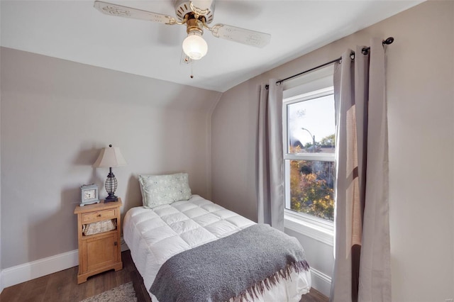 bedroom with ceiling fan, lofted ceiling, dark hardwood / wood-style floors, and multiple windows