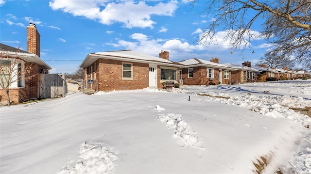 view of snow covered back of property