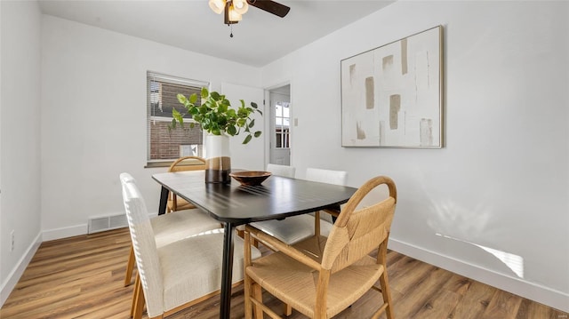 dining space featuring ceiling fan and hardwood / wood-style floors