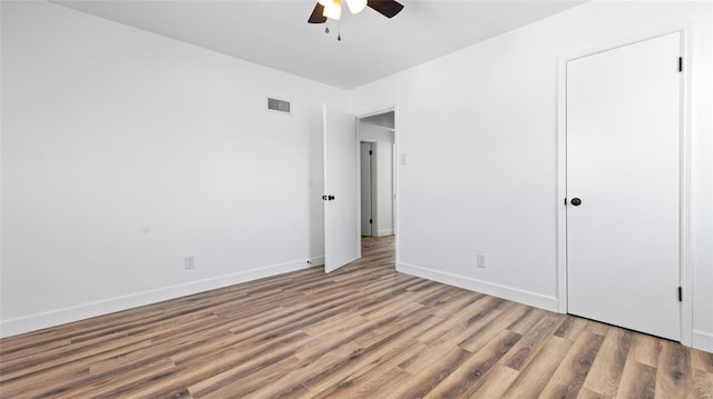 unfurnished bedroom with ceiling fan and wood-type flooring