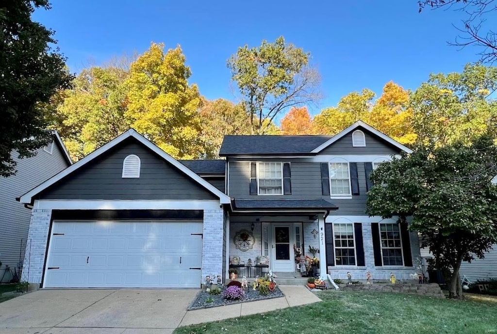 view of front facade with a front yard and a garage