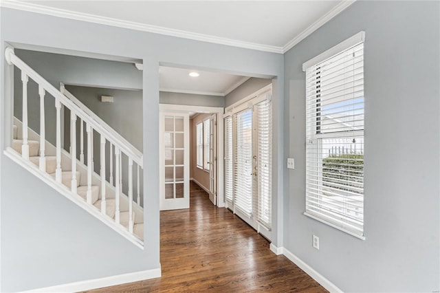 entryway with french doors, ornamental molding, a wealth of natural light, and dark wood-type flooring