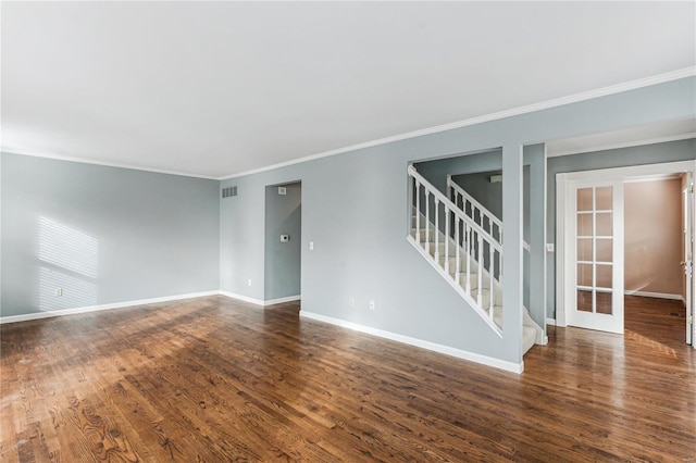 empty room with french doors, dark wood-type flooring, and ornamental molding