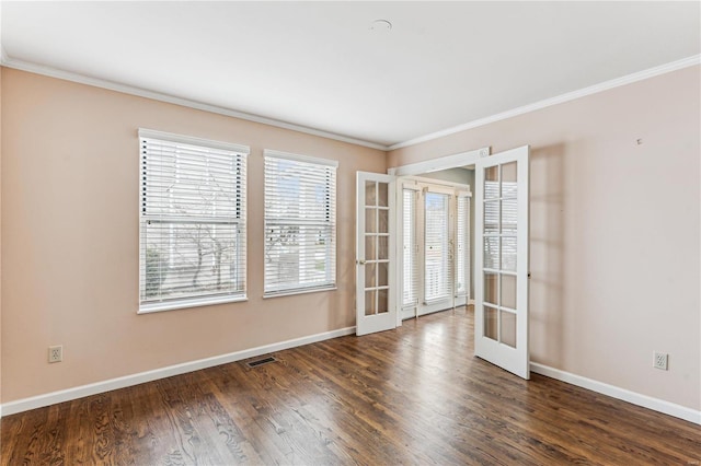 spare room featuring french doors, dark hardwood / wood-style flooring, and crown molding