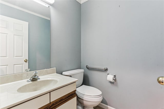 bathroom featuring vanity, toilet, and ornamental molding