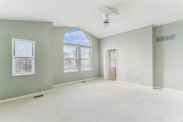 carpeted empty room with ceiling fan and vaulted ceiling