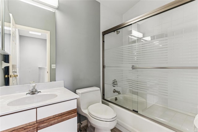 full bathroom with toilet, vanity, and combined bath / shower with glass door