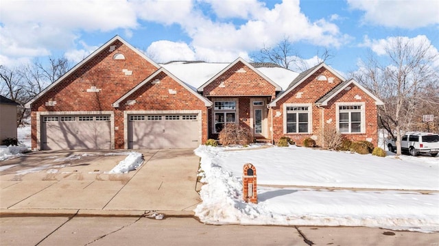 view of front of home featuring brick siding, driveway, and a garage