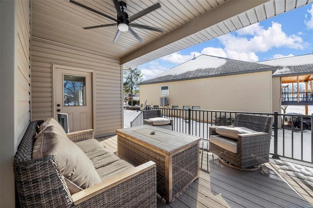 wooden deck with a ceiling fan and an outdoor hangout area