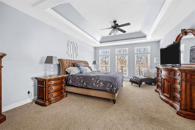 bedroom with baseboards, a raised ceiling, carpet, and ceiling fan