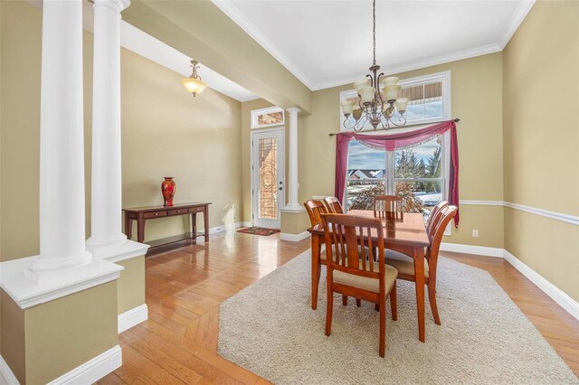 dining room featuring light wood-style floors, an inviting chandelier, and decorative columns