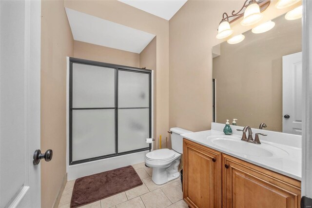 full bath featuring tile patterned floors, toilet, a stall shower, and vanity