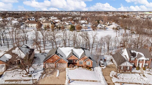 snowy aerial view with a residential view