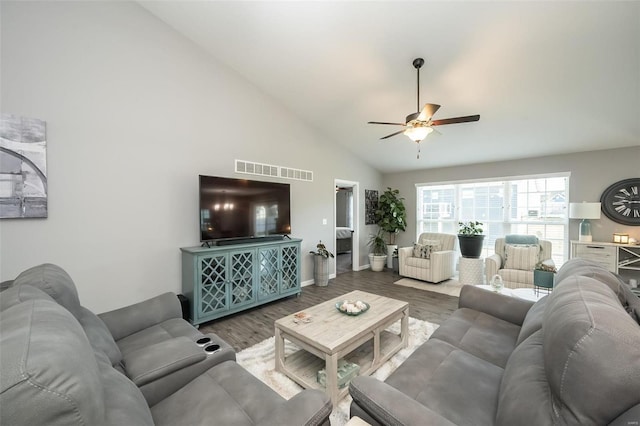 living room with hardwood / wood-style flooring, high vaulted ceiling, and ceiling fan