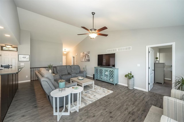 living room with ceiling fan, dark hardwood / wood-style flooring, and high vaulted ceiling