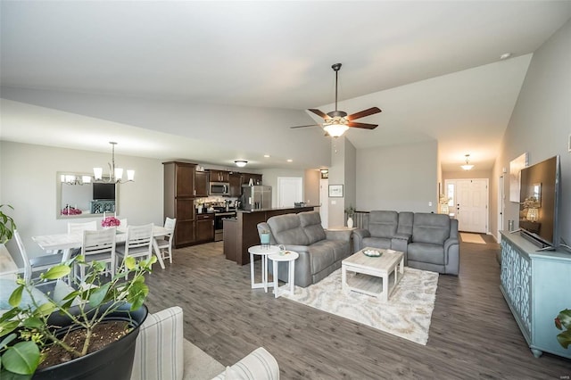 living room featuring dark wood-type flooring, ceiling fan with notable chandelier, and high vaulted ceiling