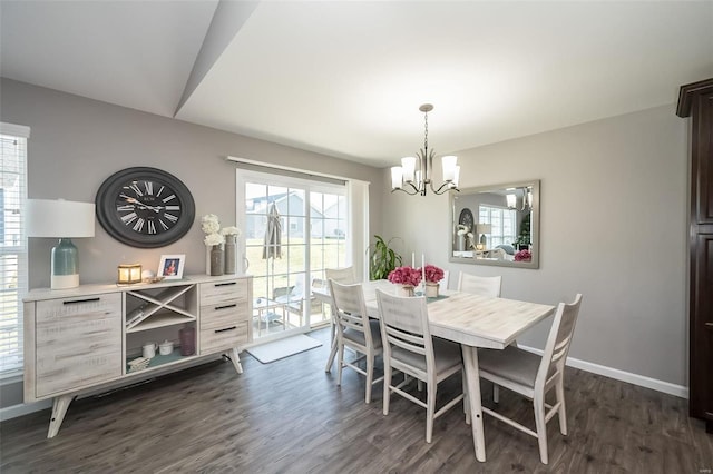 dining space with dark wood-type flooring and a chandelier