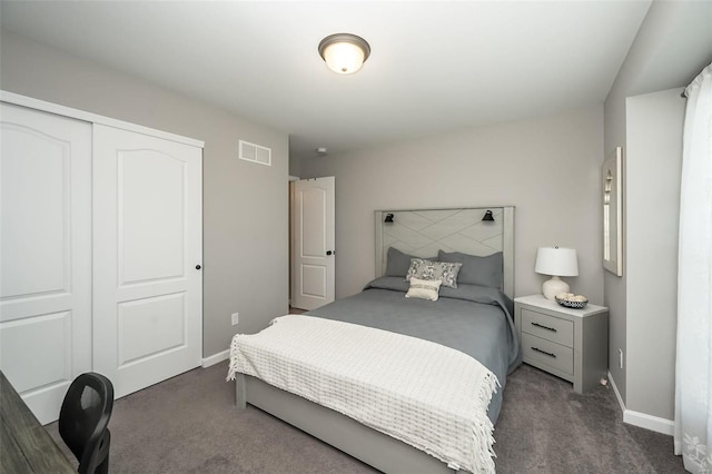 bedroom featuring dark carpet and a closet