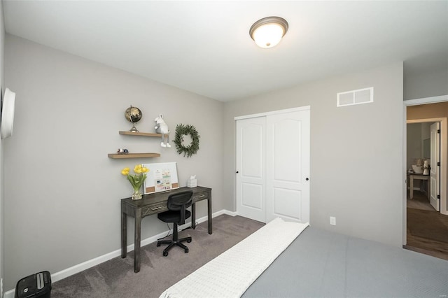 bedroom featuring dark carpet and a closet