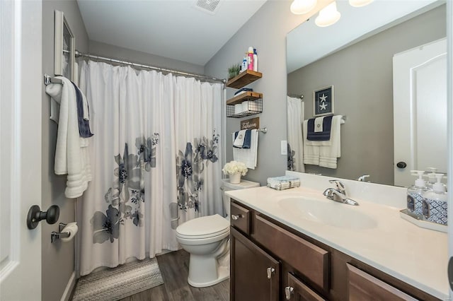 bathroom featuring vanity, curtained shower, wood-type flooring, and toilet