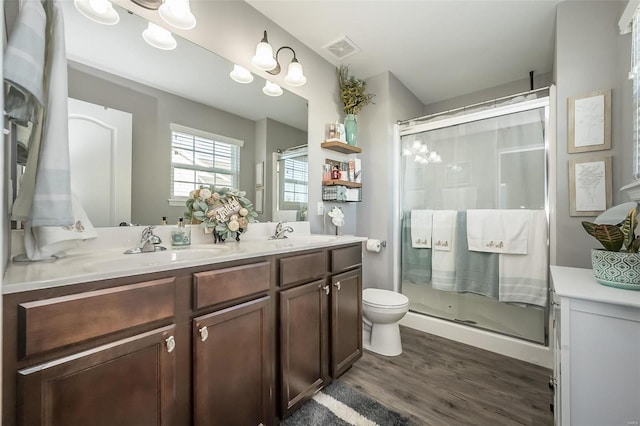 bathroom featuring vanity, hardwood / wood-style floors, an enclosed shower, and toilet