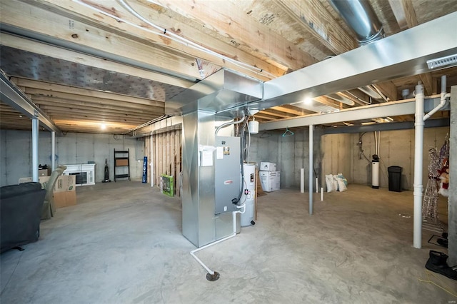 basement featuring water heater and heating unit