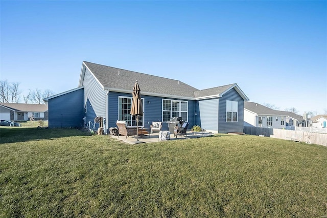 rear view of house featuring a lawn and a patio area