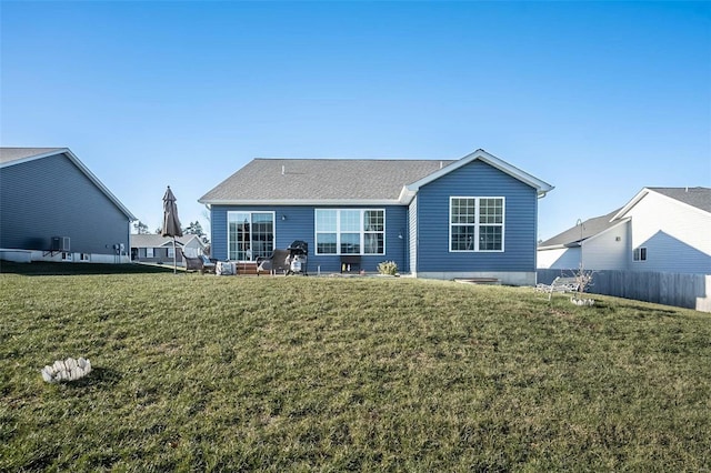 rear view of property with a yard