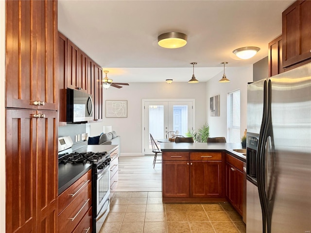 kitchen with french doors, stainless steel appliances, ceiling fan, light tile patterned floors, and decorative light fixtures