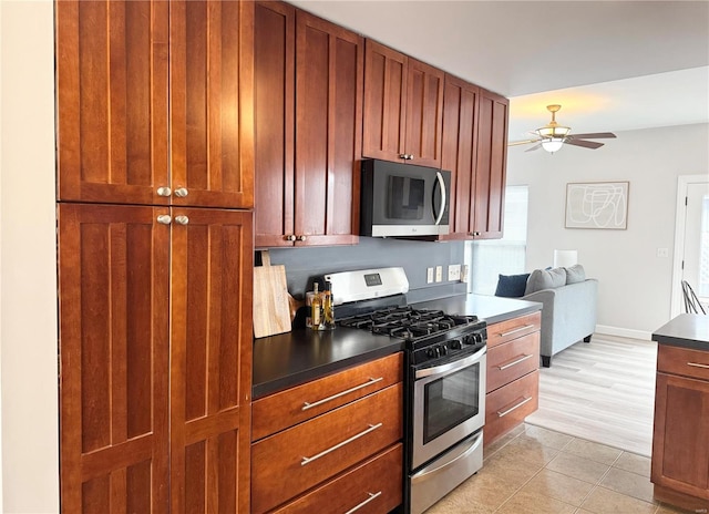 kitchen with ceiling fan, plenty of natural light, light tile patterned floors, and appliances with stainless steel finishes