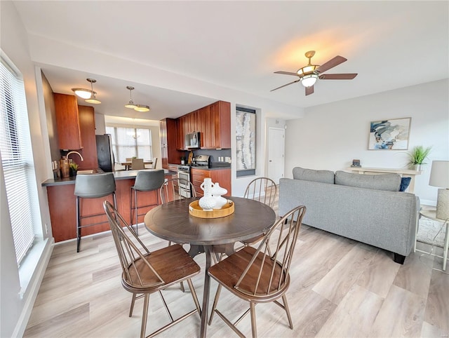 dining area featuring ceiling fan and light hardwood / wood-style floors