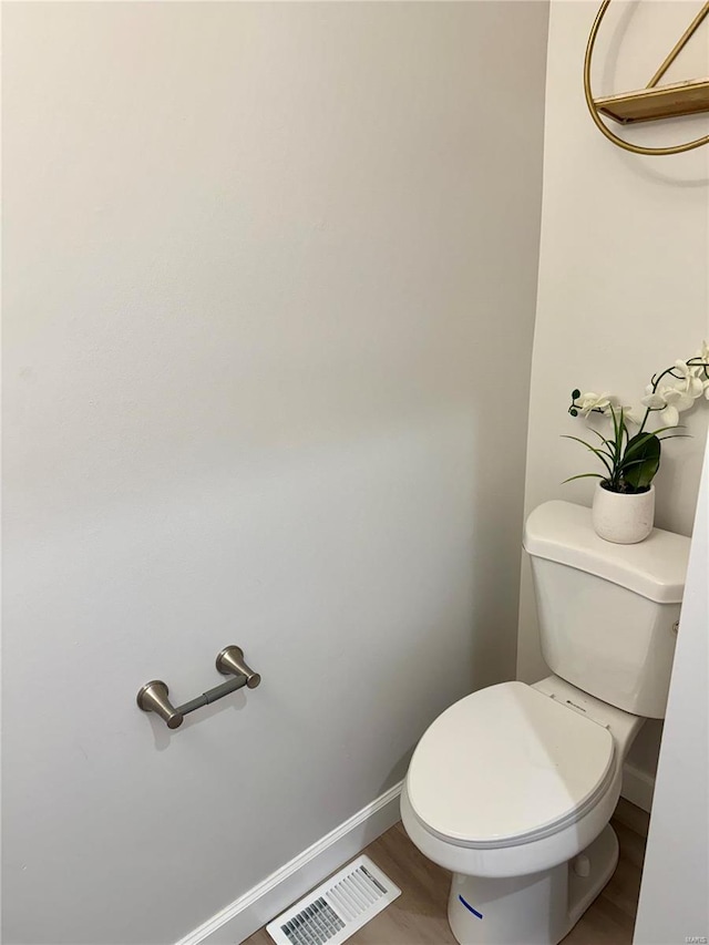 bathroom with wood-type flooring and toilet