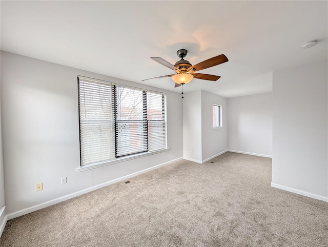 carpeted empty room featuring ceiling fan