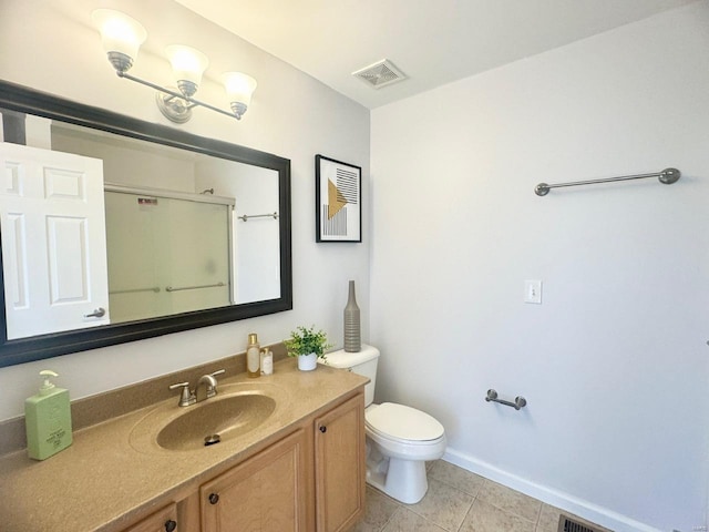 bathroom featuring tile patterned floors, vanity, and toilet