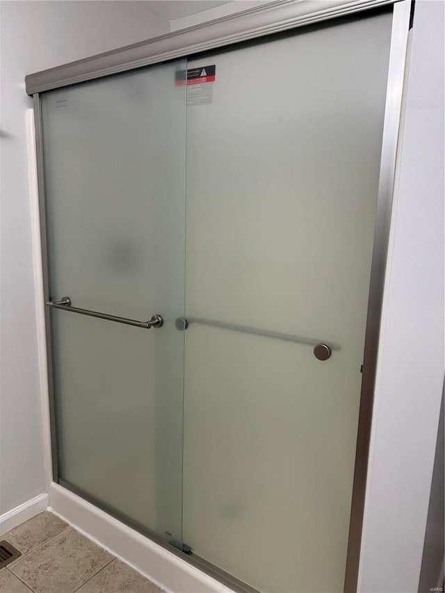 bathroom featuring tile patterned flooring and walk in shower