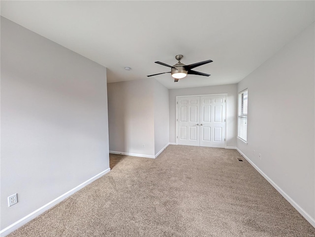 unfurnished bedroom featuring carpet, a closet, and ceiling fan