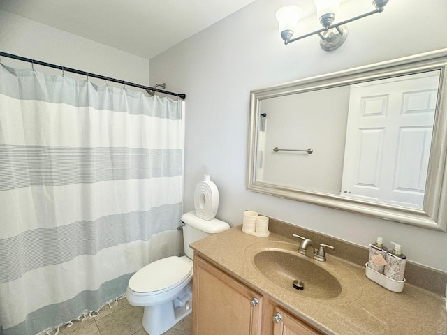 bathroom featuring toilet, vanity, tile patterned floors, and walk in shower