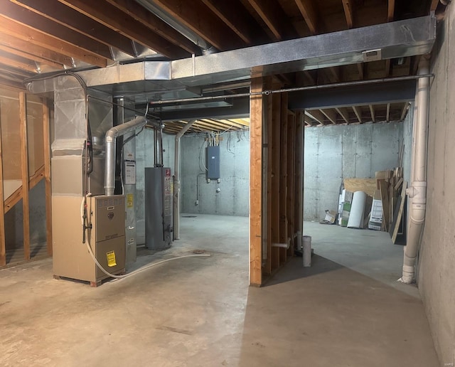 basement featuring electric panel, gas water heater, and heating unit