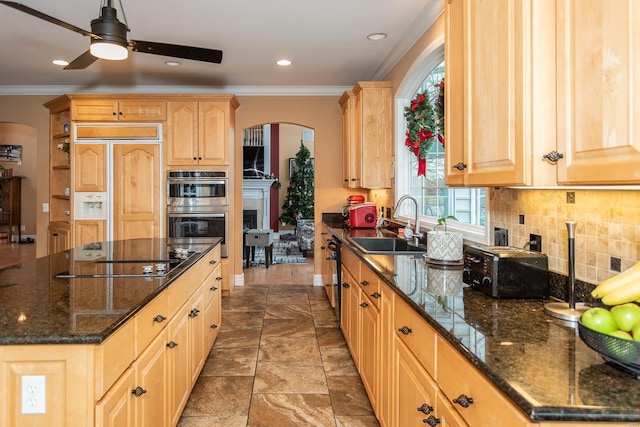 kitchen featuring sink, black electric cooktop, light brown cabinetry, paneled fridge, and stainless steel double oven