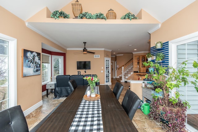 dining area with vaulted ceiling, plenty of natural light, ceiling fan, and ornamental molding