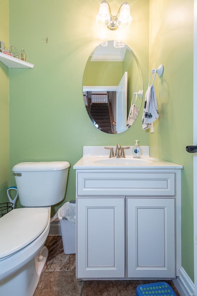 bathroom featuring vanity, toilet, and ornamental molding